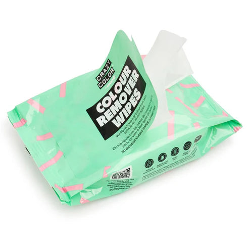 En åben grøn og pink "Crazy Color"-pakke med Color Remover Wipes / Farvefjerner viser en delvist udtrukket biologisk nedbrydelig serviet med produktoplysninger og ikoner på forsiden.